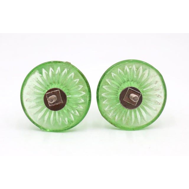 Vintage cabinet or drawer knobs made of green glass with a fluted design. The original mounting nuts are included. Good...