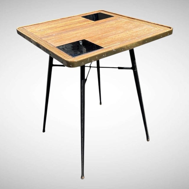This table exemplifies Jacques Adnet's signature style, characterized by the combination of metal and saddle leather....
