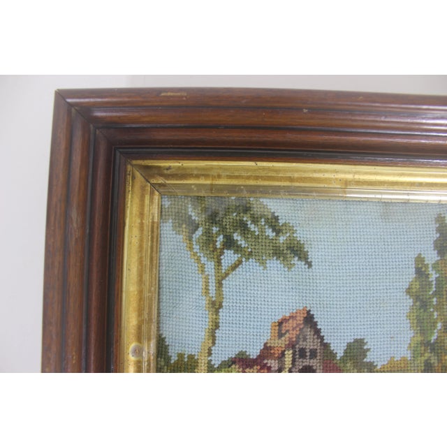 Antique wood framed embroidery with gold. The frame is thick and heavy and the glass has bubbles and some scratches in it,...