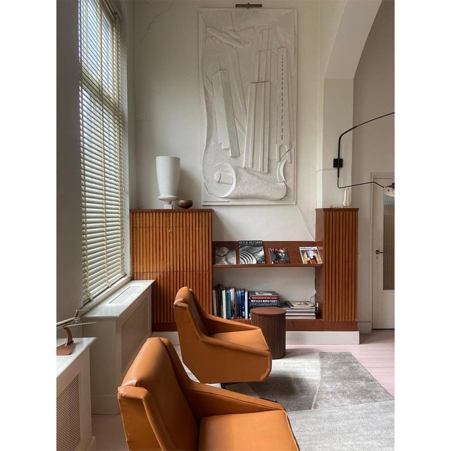 This set of two vintage design armchairs exudes timeless elegance. Period: 1950s-1960s. The warm cognac-colored faux...