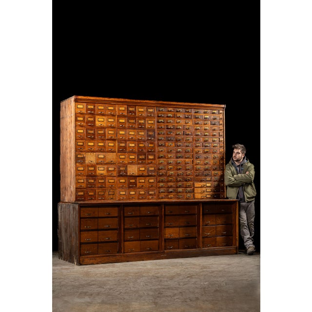 c. 1910s; Duluth Show Case Co. - Duluth, MN Large, antique wooden parts cabinet. This piece, likely constructed from oak,...