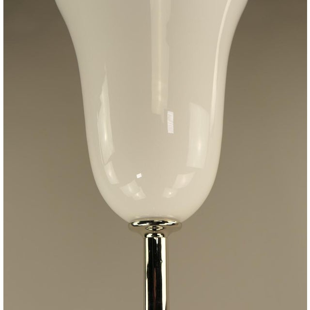 Floor lamp made of solid chromed brass with an exceptional overall size (with shade) of 182 cm. The hand-blown opal glass...