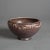 An antique Arts and Crafts bowl by Rookwood offers tapered form with stylized foliate band and maker mark on base as...