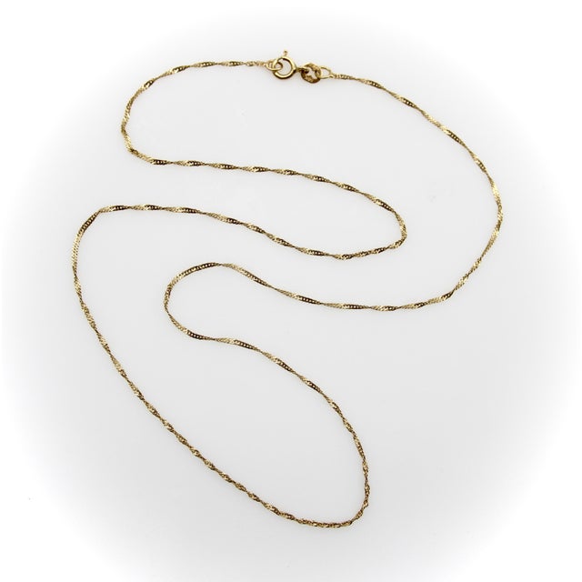 This is a sweet version of a twisted baby curb link chain in 14k gold. The chain’s construction creates a spin to the...