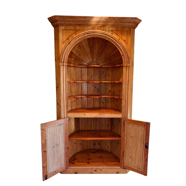 Beautiful solid wood corner hutch cabinet in very good condition. This piece features a classic arched top with decorative...