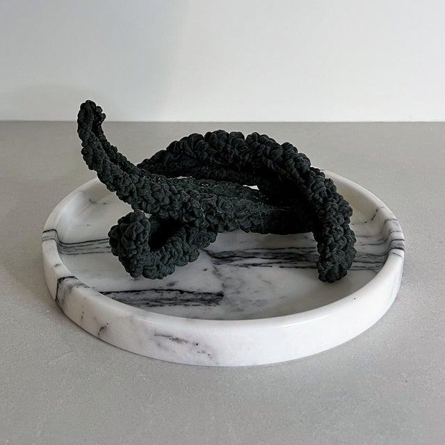 Handcrafted from richly veined white marble, the Vanda Tray is defined by its clean circular form and subtly raised edge....