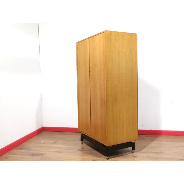 A gorgeous armoire by renowned British furniture maker G Plan, this vintage blonde double wardrobe perfectly embodies the...