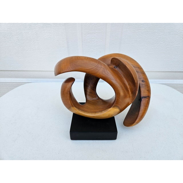 A contemporary freeform wooden sculpture by British artist John Spielman. This piece swivels atop an ebonized wooden...