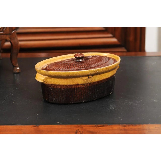 A rustic French covered pâté tureen from the 19th century with brown glaze. Created in France during the 19th century,...