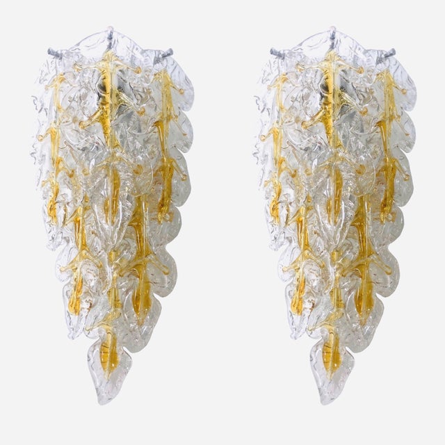 Marvelous, stunning and long italian set of six clear amber murano glass wall sconces from 1970s. These fixtures were...