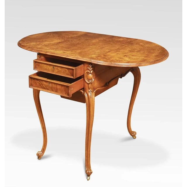 Walnut side table the well figured top having lift up ends and moulded edge. Two the freeze fitted with drawers and sewing...