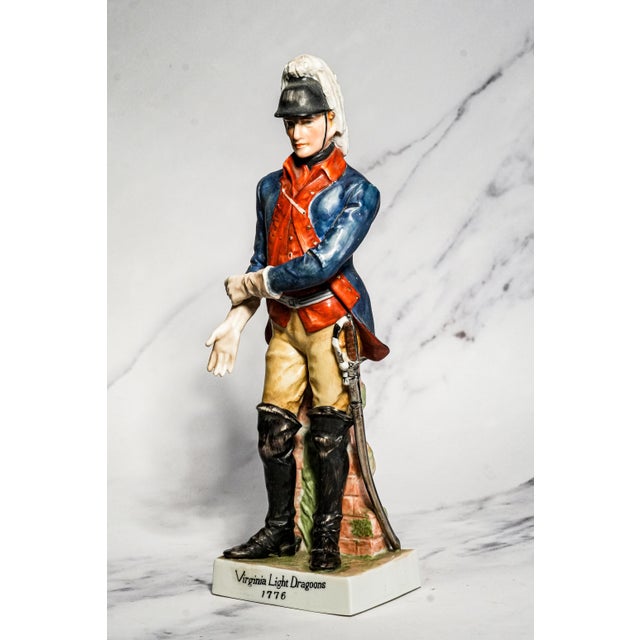 This handsome mid-century hand-painted porcelain figurine depicts a soldier of the Virginia Light Dragoons of 1776,...