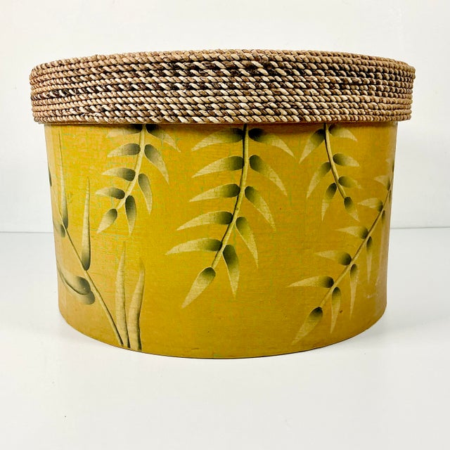This is a really nice decorative storage box. The round box features a wicker rope lid over a Bamboo leaf motif covered...