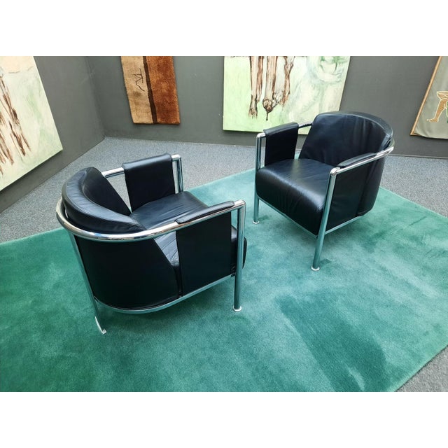 Two elegant club chairs from Italy. Originally purchased in Milan. Seat cushions, back cushions, and armrests covered in...
