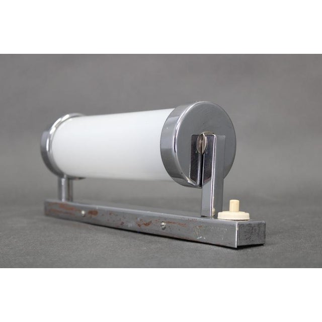 This czechoslovak tubular wall light from the 1930s represents a refined intersection of bauhaus functionalism and...