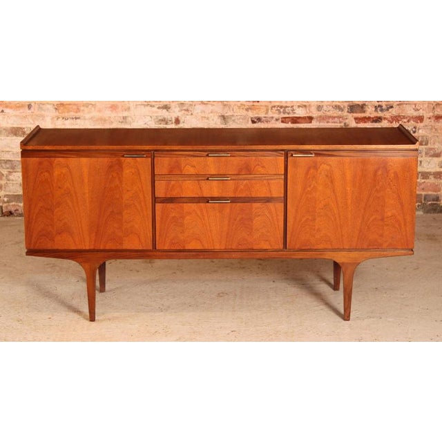 Mid Century teak sideboard by Meredew, circa 1960s. 2 cabinet sections and 3 drawers, including felt lined cutlery drawer...