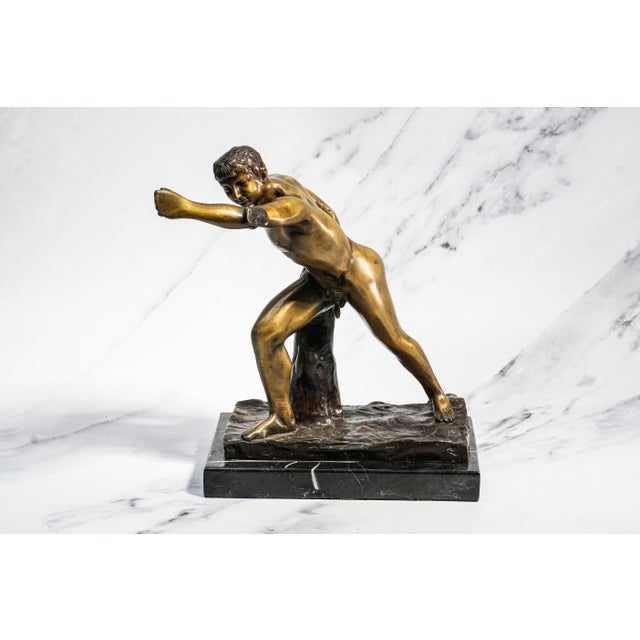A striking decorative sculpture inspired by the celebrated Borghese Gladiator, this vintage cast metal figure captures the...