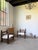 Pair of dark oak armchairs from the 1950s attributed to charles dudouyt. their compact design, with low seats, is...