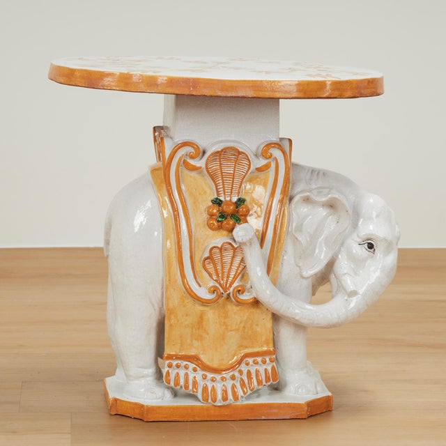 Mid century Italian elephant stand crafted in terra cotta, with a removable top, hand decorated in delightful pastel...
