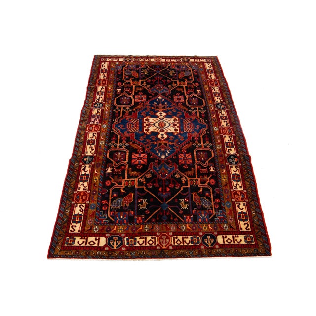 This remarkable vintage Persian Hamadan rug is hand-knotted and designed with a blue field. It also incorporates a variety...