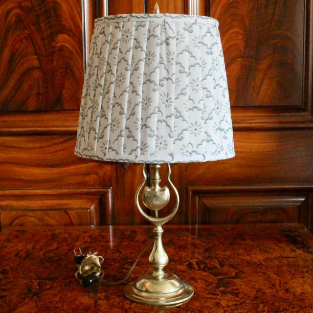 A quirky English brass candlestick, of unusual form, adapted into a lamp with recent wiring including an inline switch and...