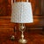 A quirky English brass candlestick, of unusual form, adapted into a lamp with recent wiring including an inline switch and...