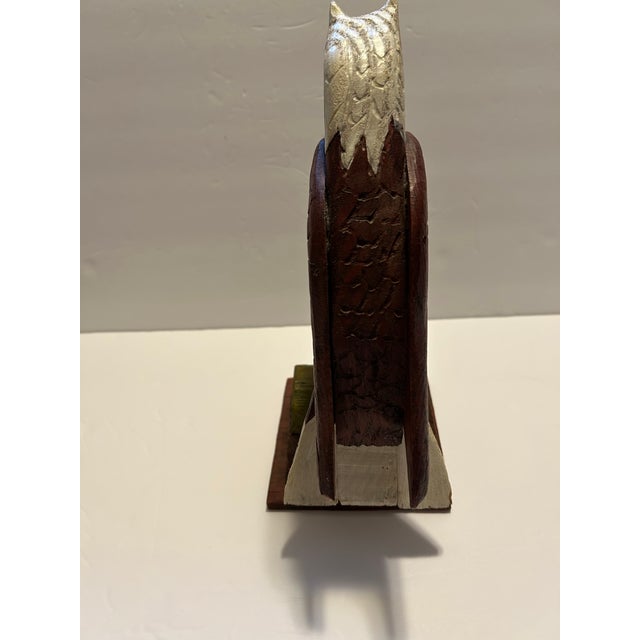 This is a vibrant hand made rustic Folk Art painted wood eagle perched on a tree limb. The painted colors of dark reddish...