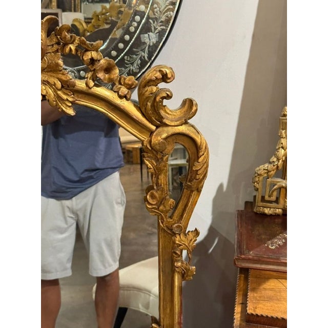 This product is a 19th-century French Louis XV giltwood mirror. This exquisite piece features intricate detailing and...