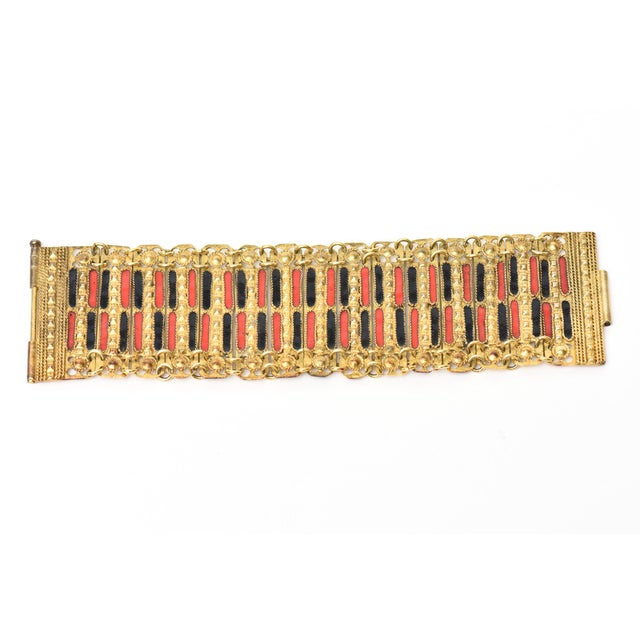 This beautiful vintage Grecian cuff bracelet is a combination of red and black enamel set against gold plated metal with...