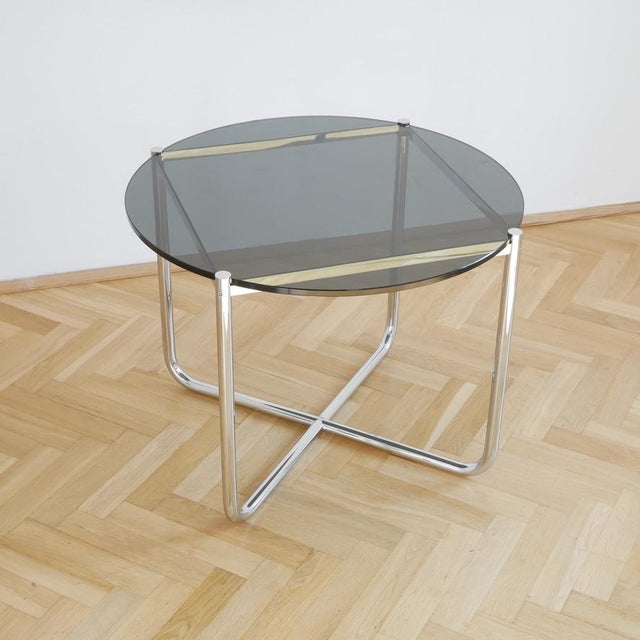 This original knoll mr table with a smoked glass top is one of the most iconic tubular steel designs of the 20th century....