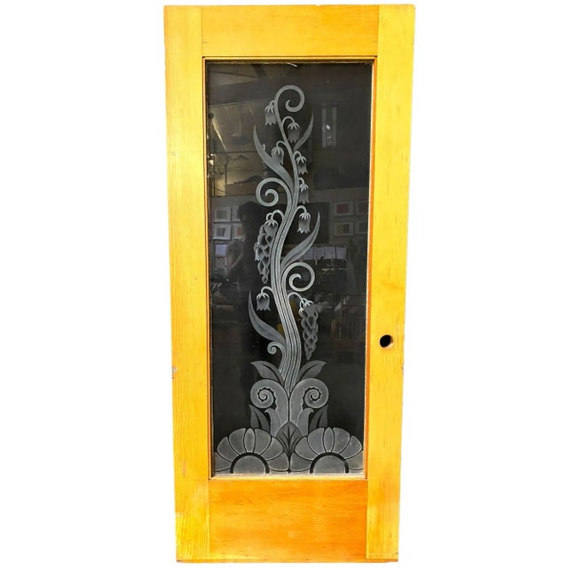 Custom-made hand-etched/cut art glass door, featuring an organic vine pattern coming out of a geometric floral at the...