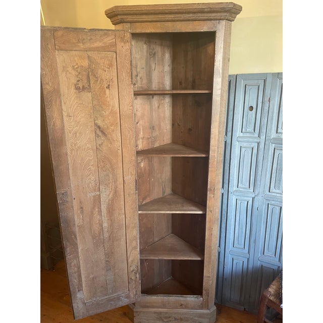 A beautiful corner cabinet from the mid-19th century in France. Crafted from walnut and oak, it has a warm, beautiful...