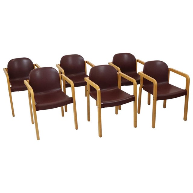 Set of 6 vintage design chairs made of steam-bent beechwood with burgundy-red synthetic seats; this is the ‘Dolmas’ model...