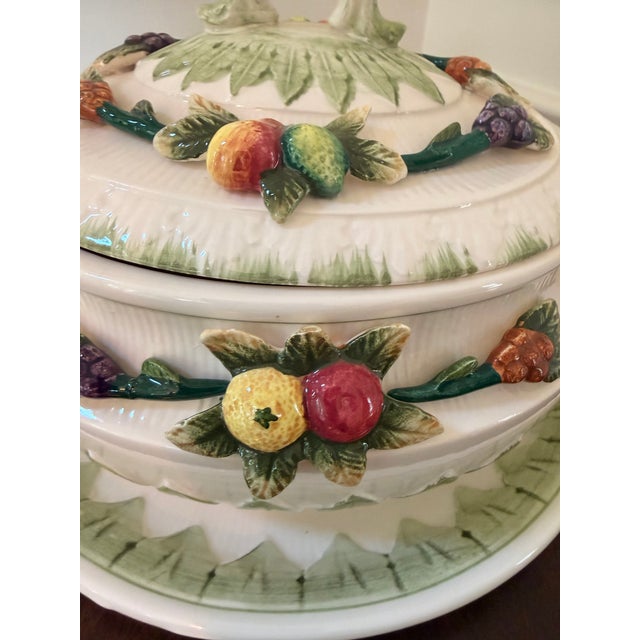 A charming vintage Japanese majolica-style soup tureen featuring richly detailed applied fruit garlands, leafy handles,...