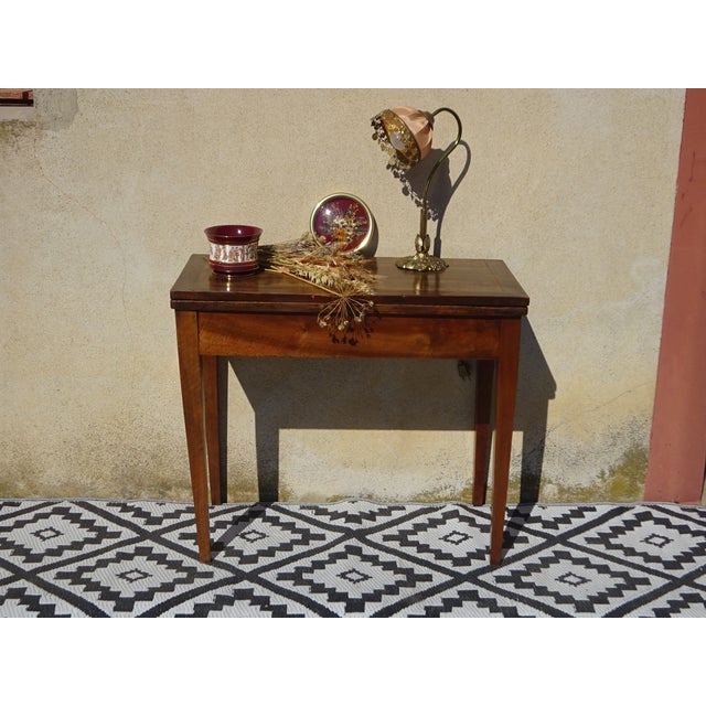 Folding games table in a simple, straight console style, made of solid walnut. Antique furniture from the 19th century....