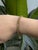 A masterpiece of timeless elegance, this yellow gold Tennis bracelet features a flowing wave design that gracefully frames...