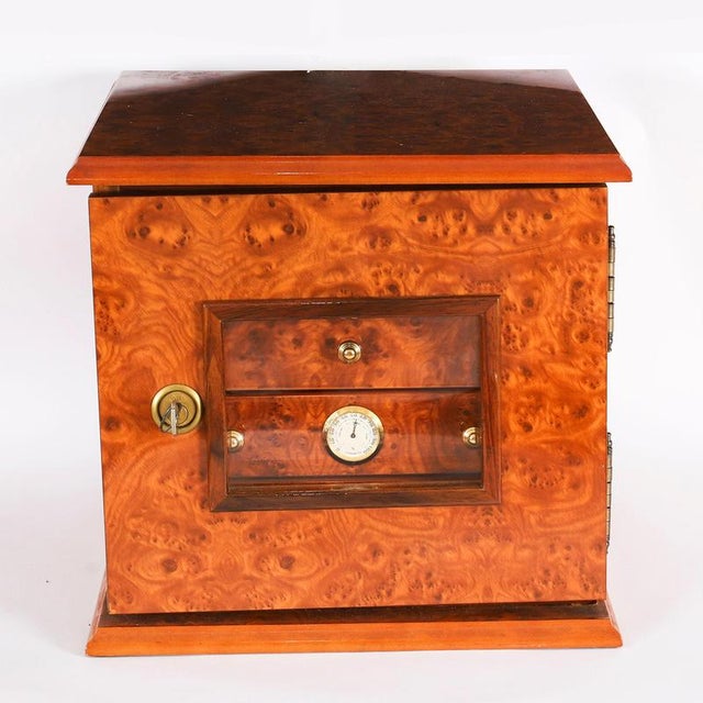 This is a stylish vintage burr elm table top cigar humidor cabinet, mid-20th century in date. The square cabinet features...