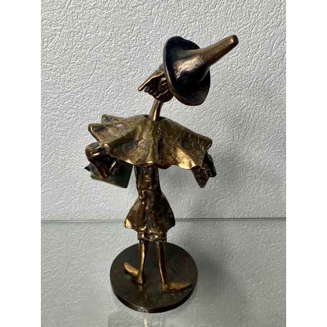 Bronze sculpture with golden patina of a clown with his briefcase. The contemporary French artist Yves Lohe is known for...