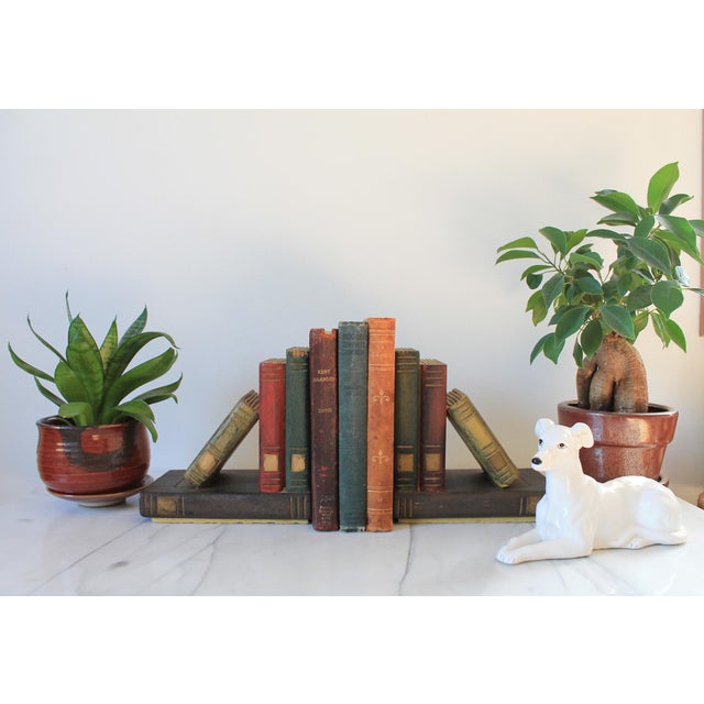 Pair of vintage faux book bookends. Marked "Hanford's". Made in Thailand. Some chips to wood. Pictured.