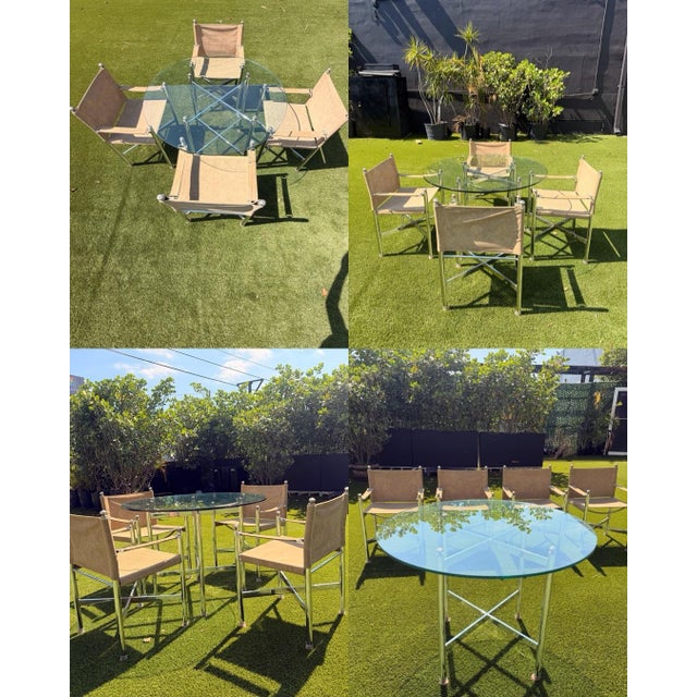 Four vintage campaign-style director’s arm chairs and Table set. Dating to the late 20th century, executed in suede...