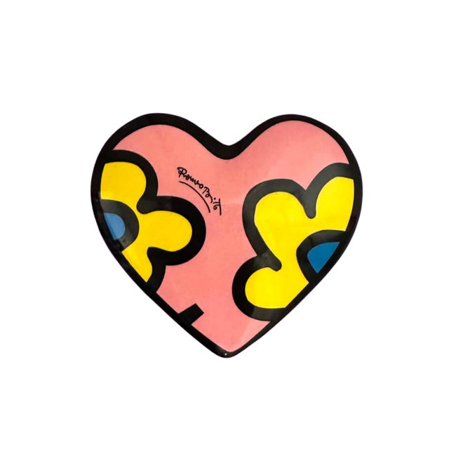 A vibrant heart-shaped paperweight by internationally acclaimed Pop artist Romero Britto, whose unmistakable visual...