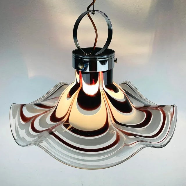 Original impressive murano pendant lamp, produced by av mazzega in italy, in the 1970s. The shade is molded by hand. The...