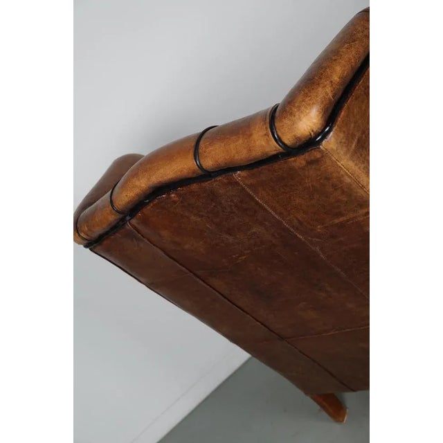 This cognac-colored leather club chair comes from the Netherlands. It is upholstered with cognac-colored leather and...