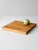 Vintage handmade wood cutting board featuring a thick, square form and warm honey-toned grain. The surface displays...