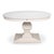 A densely carved pedestal gives the pale circular top a substantial architectural foundation. The round top reads as one...