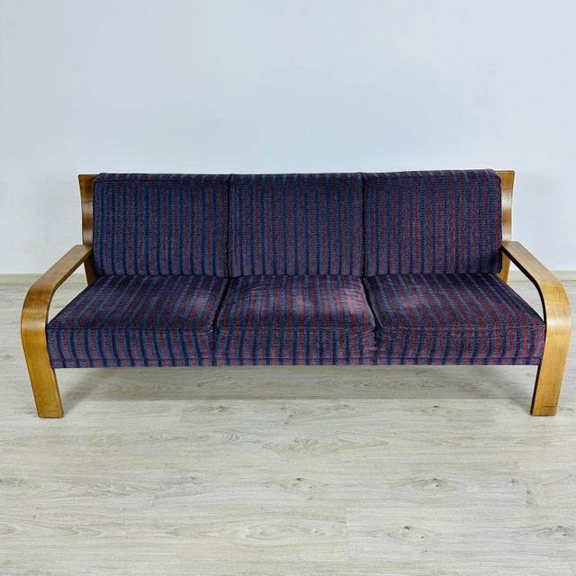 Dimensions: H 31” x W 78.3” x SD 21” x SH 16”. Vintage bentwood three-seater sofa designed by Walter Knoll, upholstered in...