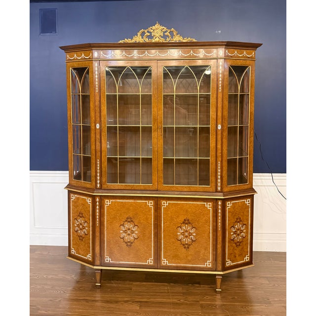 This is the Finneas Display Cabinet by Maitland - Smith. Its features Burled Myrtle Wood with Gold Gilt and Shell inlays...