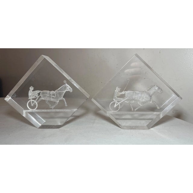 Up for sale is a very high quality pair of carved clear lucite figural bookends in the form of harness jockeys. They are...