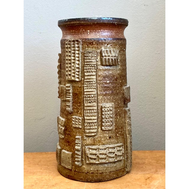 Description: This vintage pottery vase is a compelling example of Mid-Century Modern ceramic artistry, distinguished by...