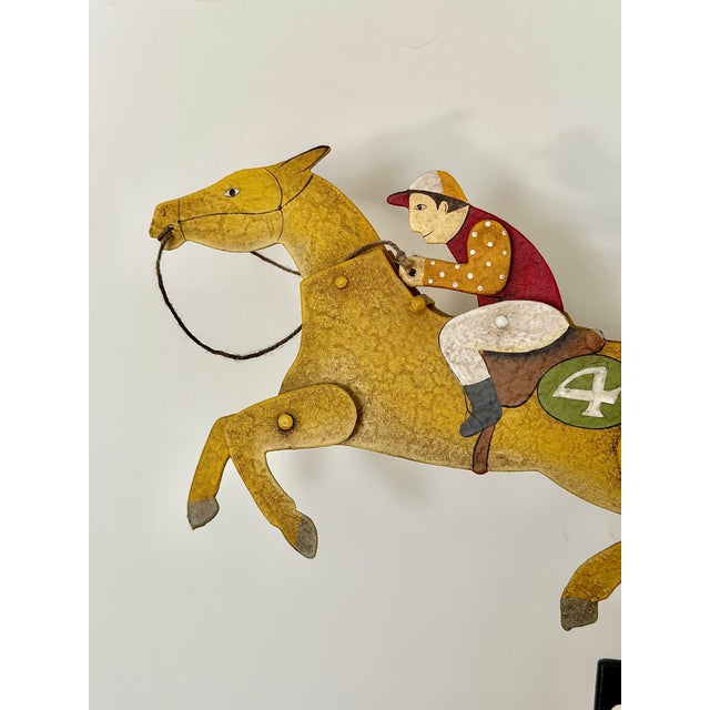 A beautifully made A La Maison horse balance toy from 2006, featuring a hand painted racehorse and jockey on a slender...